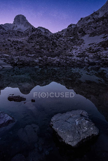 Scenic view of still mountain lake at dusk — Stock Photo
