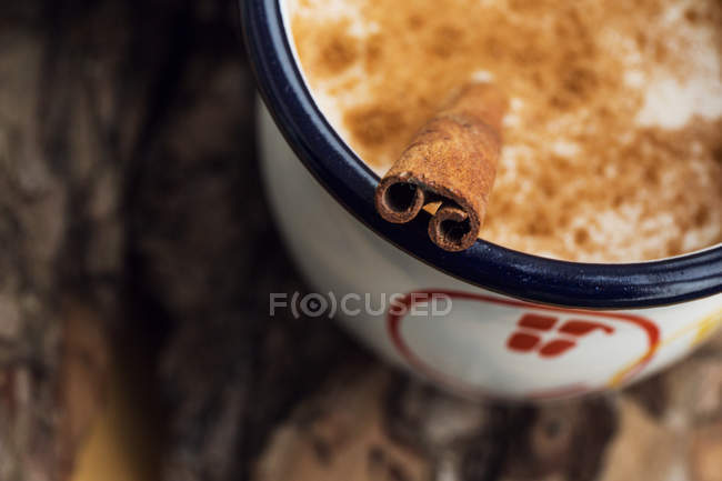 Elevated closeup view of milk with cinnamon — Stock Photo