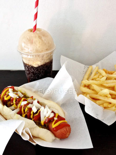 Concept of old school fast food, hot dog, cola and french fries — Stock Photo