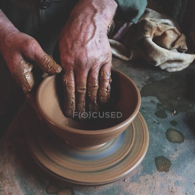 Cropped image of person making pottery indoors — Stock Photo