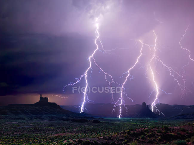 A lightning storm illuminating the north end of Utah Valley of the Gods, USA — Stock Photo