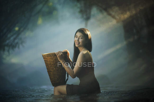 Beautiful asian woman in waterfall, Thailand (classic tone) — Stock Photo