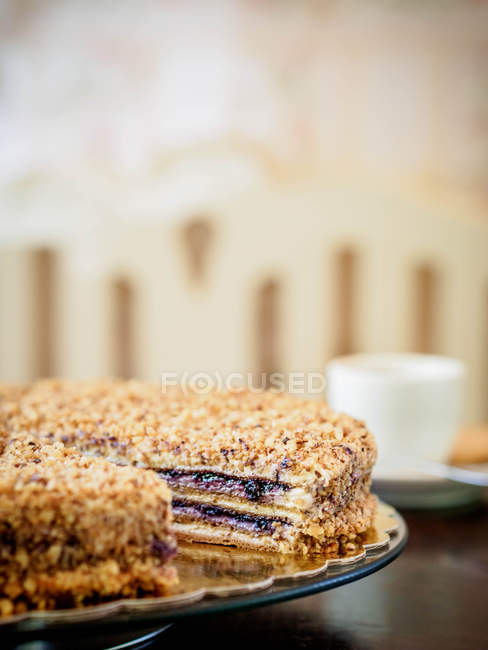Close-up of a raspberry and nut  cake with missing slice — Stock Photo