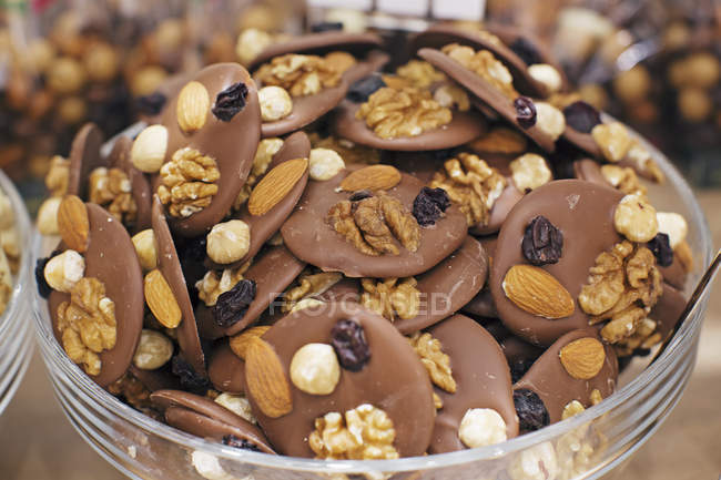 Chocolate with nuts and raisins, closeup view — Stock Photo