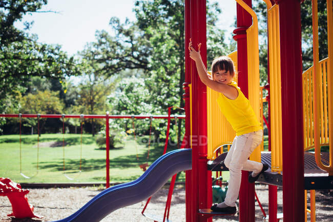 Adorable little Girl playing in a playground — Stock Photo