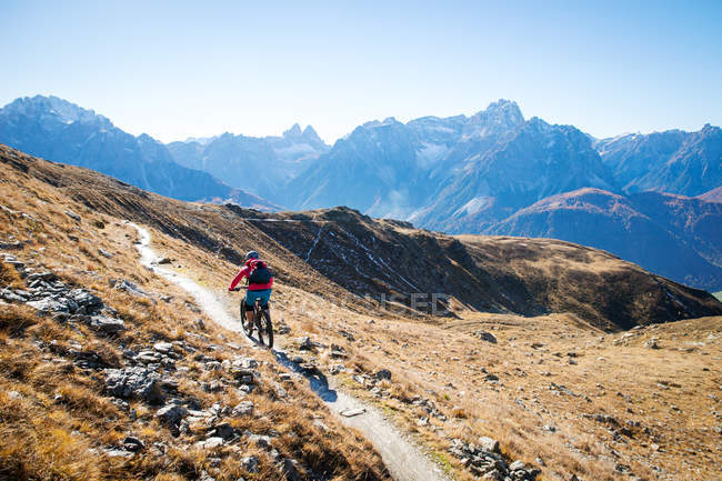 Woman mountain biking in Dolomites, South Tyrol, Italy — Stock Photo