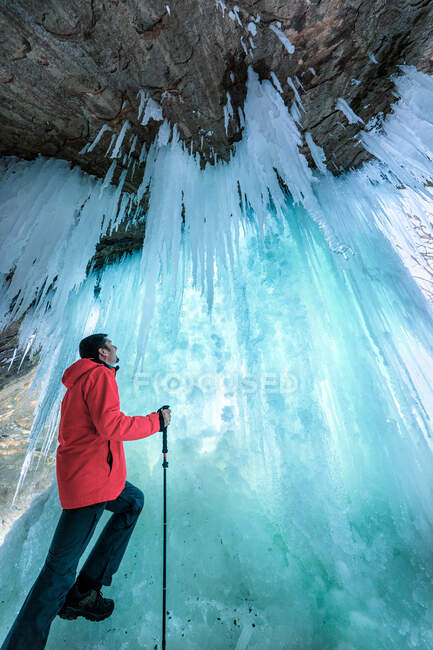 Mann steht hinter einem gefrorenen Wasserfall, Matthiessen State Park, Illinois, Amerika, USA — Stockfoto