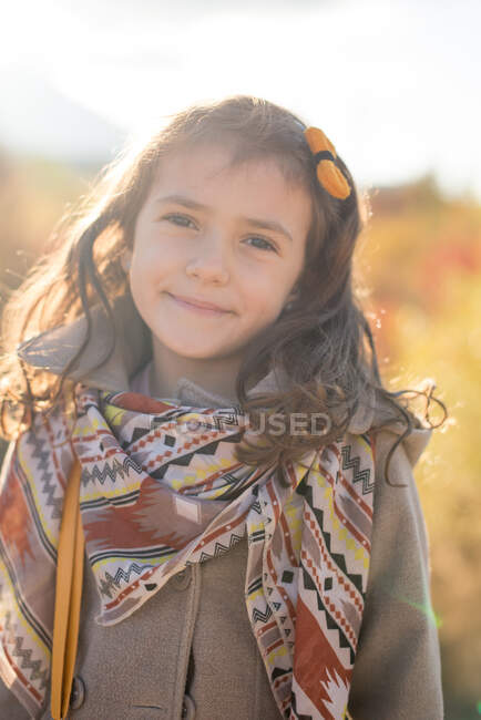 Portrait of a smiling girl in autumn sun — Stock Photo