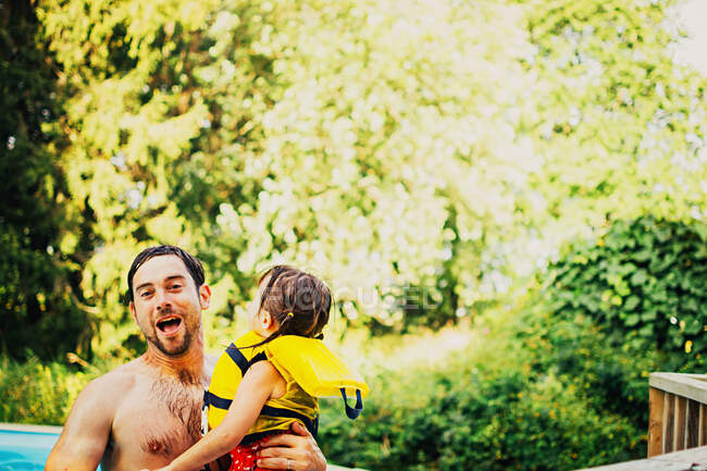 Отец и дочь возятся в бассейне — стоковое фото