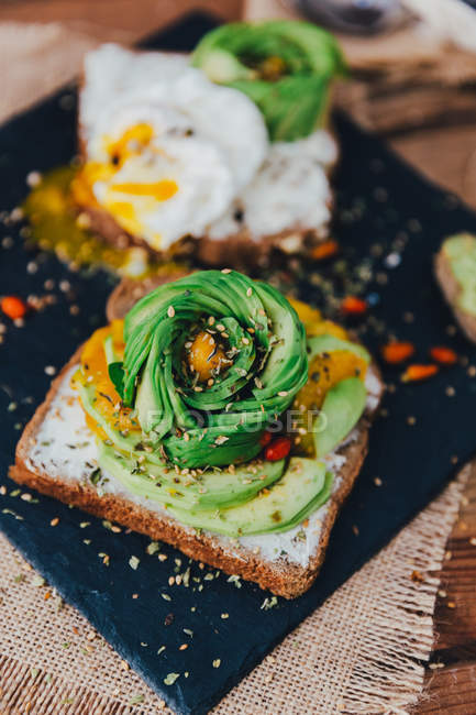 Avocado toast with egg, closeup view — Stock Photo