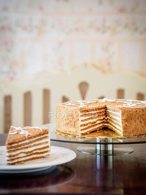 Slice of French layer cake and serving of cake — Stock Photo