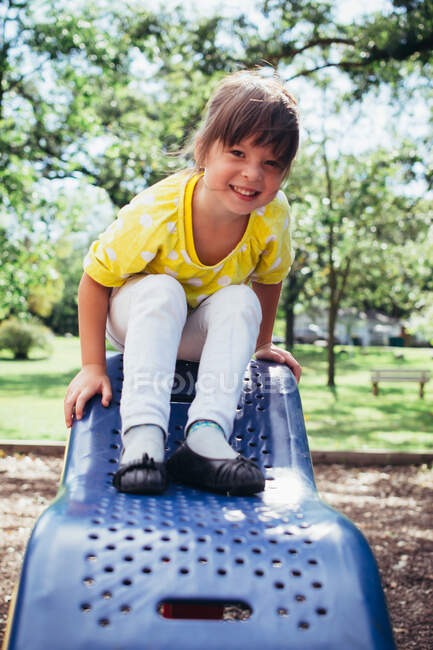 Adorable petite fille souriante dans aire de jeux — Photo de stock