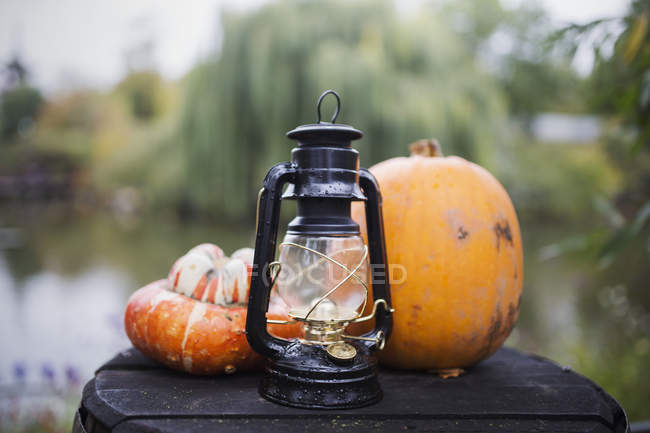 Halloween pumpkins and a lantern, closeup view — Stock Photo