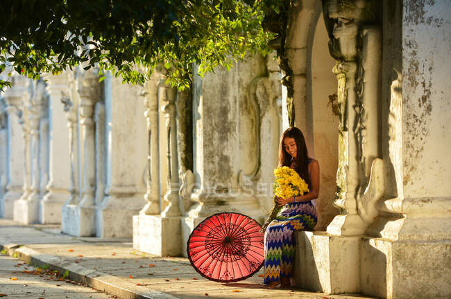 Giovane donna seduta fuori dal tempio, Mandalay, Myanmar — Foto stock