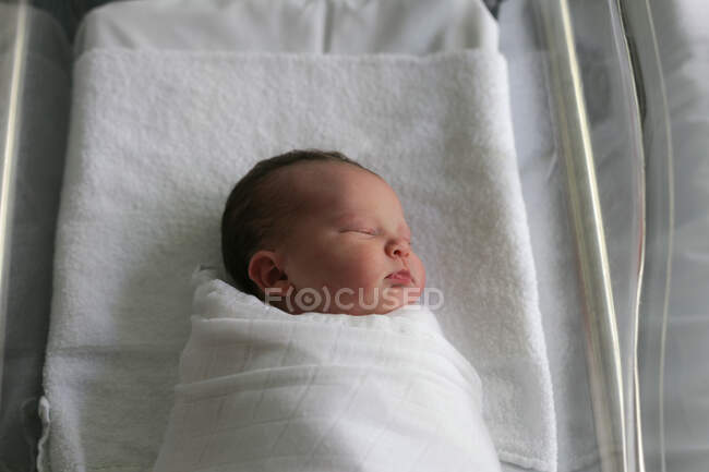 Newborn baby wrapped in a blanket — Stock Photo