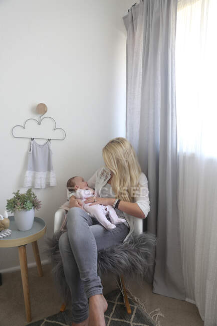 Woman sitting with newborn baby — Stock Photo