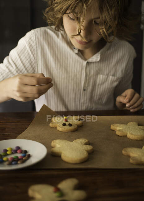 Jovem loira menino decoração cookies — Fotografia de Stock