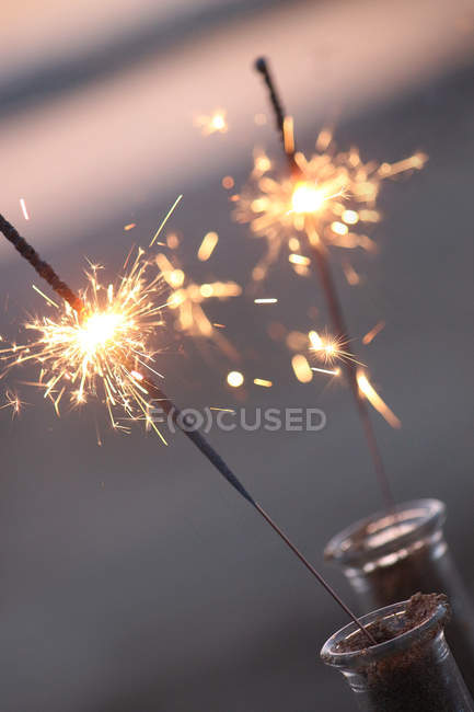 Closeup view of Lit sparklers on the beach - foto de stock
