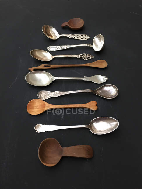 Selection of metal and wooden spoons — Stock Photo
