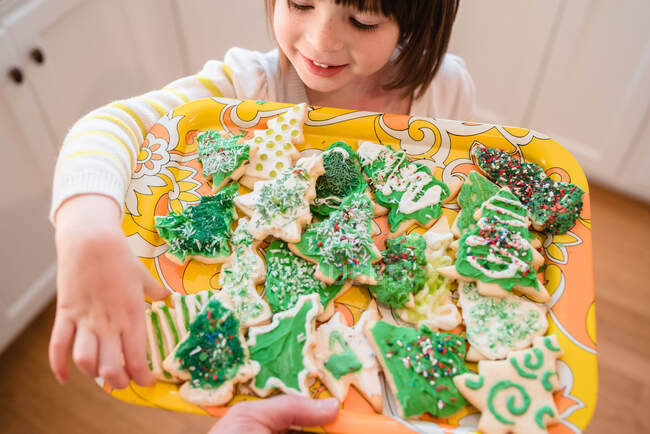 Girl picking out a Christmas cookie — Stock Photo