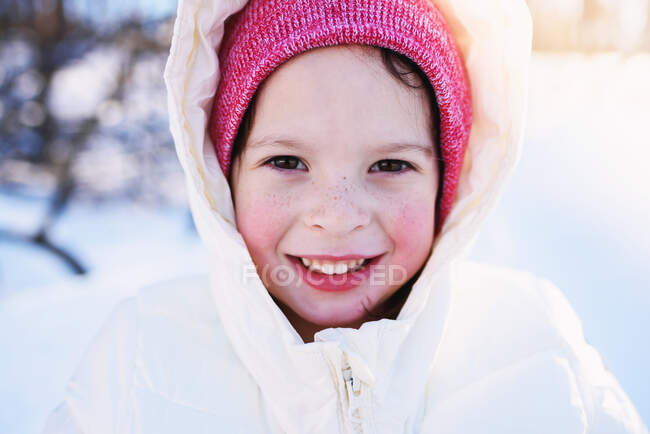 Portrait of a girl in warm clothing in the snow — Stock Photo