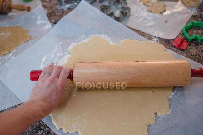 Жінка розкачує тісто для різдвяного печива — стокове фото