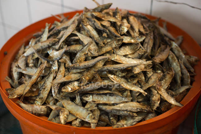 Air-dried fish in a bucket at fish market — Stock Photo