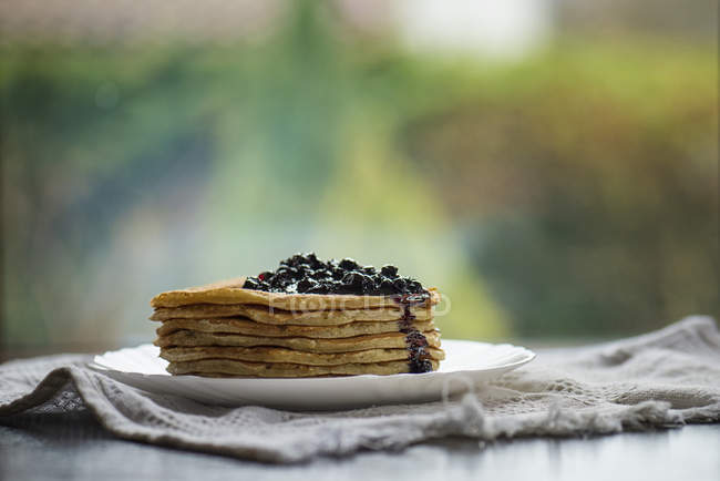 Stack of blueberry pancakes against blurred background — Stock Photo