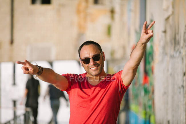 Portrait of a man making peace sign, Lisbon, Portugal — Stock Photo