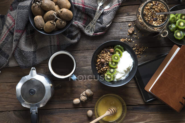 Гранола, киви фрукты и йогурт с кофе — стоковое фото
