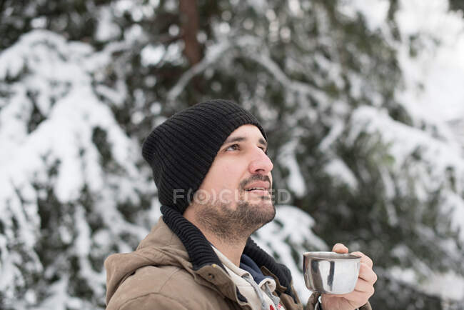 Mann trinkt Tasse Tee im Schnee — Stockfoto