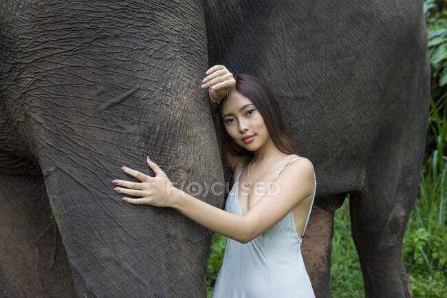Woman leaning against an elephant, Tegallalang, Bali, Indonesia — Stock Photo