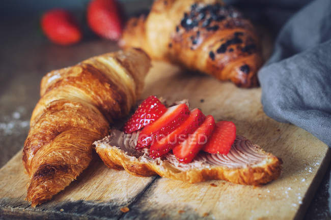 Croissants with chocolate cheese spread and fresh strawberries — Stock Photo