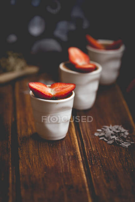 Three pots of chocolate mousse with strawberries — Stock Photo