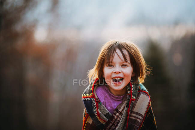 Portrait of a girl wrapped in a patchwork quilt — Stock Photo