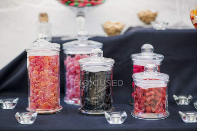 Candy bar table with jars of sweets — Stock Photo