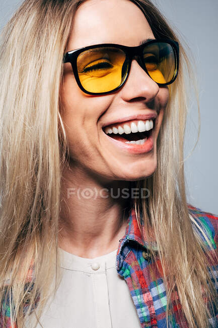 Retrato de uma mulher rindo em fundo cinza — Fotografia de Stock