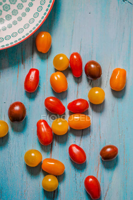 Cherry tomatoes on wooden table, top view — Stock Photo