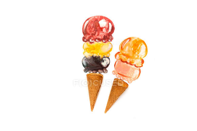 Conceptual ice-cream cones over white background — Stock Photo