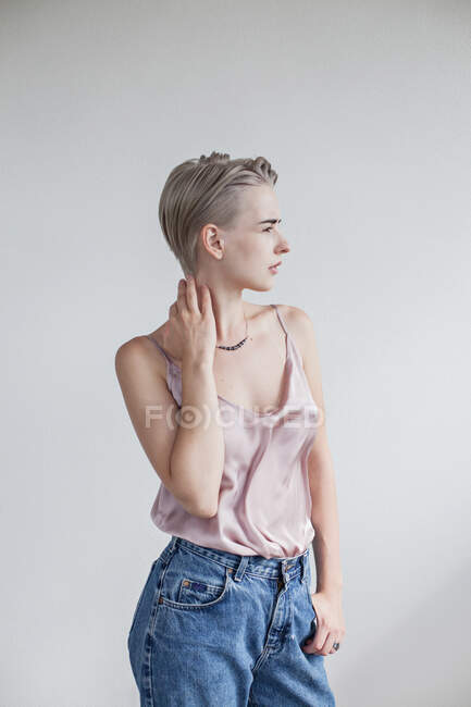 Portrait of a blonde woman with her hand on her neck — Stock Photo
