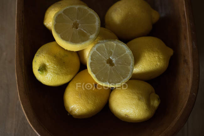 Closeup view of lemons in wooden bowl — Stock Photo
