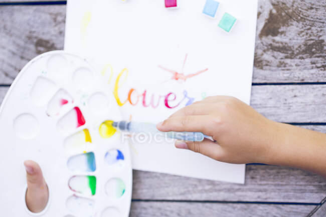Boy painting with watercolor paints — Stock Photo