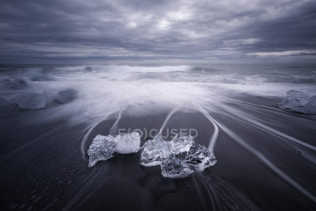 Ледяной покров на черном песчаном пляже, Лагуна Йокулсалон, Фафьордур, Исландия — стоковое фото