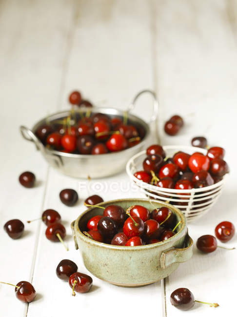 Closeup view of Bowls of cherries on white — Stock Photo