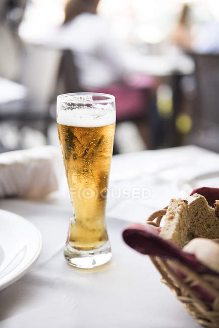 Glass of beer on a table at lunch — Stock Photo