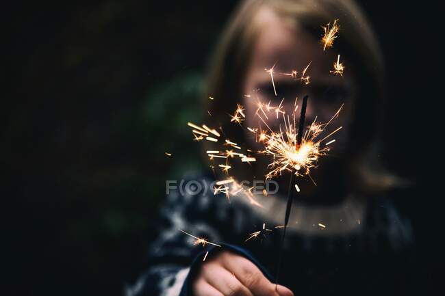 Portrait of a smiling Boy holding a sparkler — Stock Photo