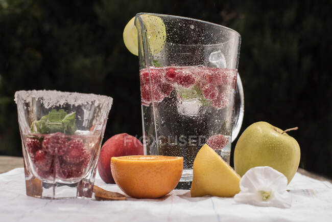 Fresh cold cocktail with ice and lemon on wooden background close up — Stock Photo