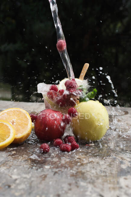 Fresh fruits on the water — Stock Photo