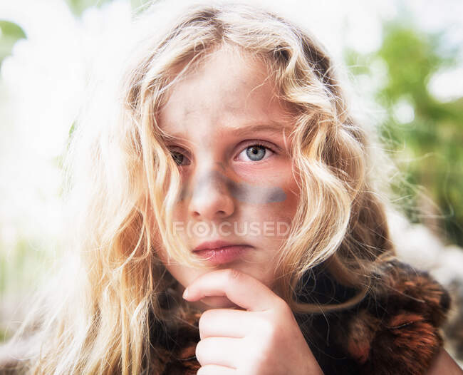 Portrait of a girl with war paint on her face — Stock Photo