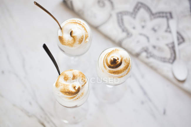 Merengue and chocolate cups over table, top view — Stock Photo